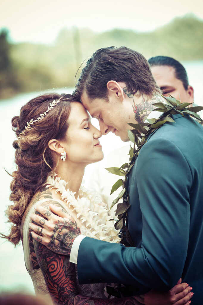 loving wedding couple bride and groom saying the vows at the beach