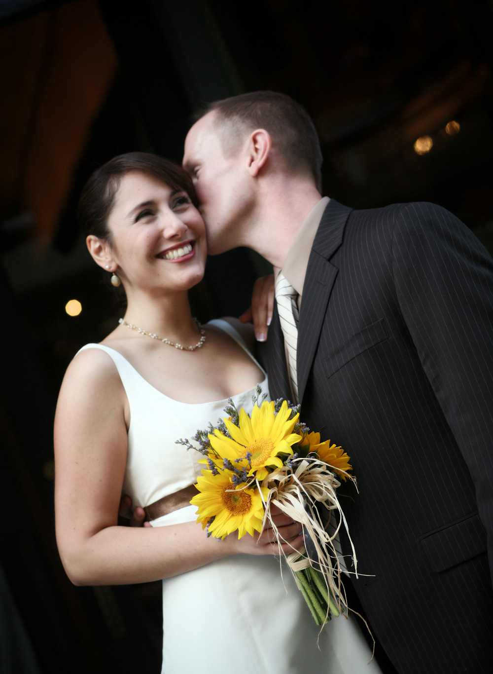 groom whispering in the ear to the bride